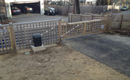 Wooden cantilever gate installed on sloped driveway