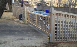Wooden slide gate fastened to aluminum track