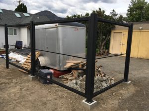 Steel fence posts mounted onto cement pads.