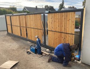 Welding eye loop to gate frame to hold bracing wire.