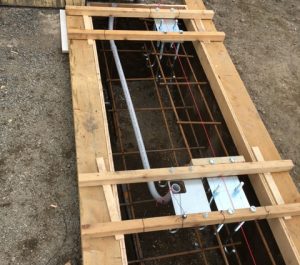 Reinforced foundation frame with J-Bolts tie rods to hold carriage foundation plates, conduit to run power to the gate operator.