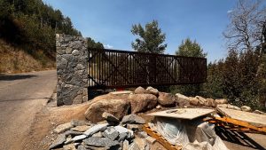 Gate is open over sloped terrain