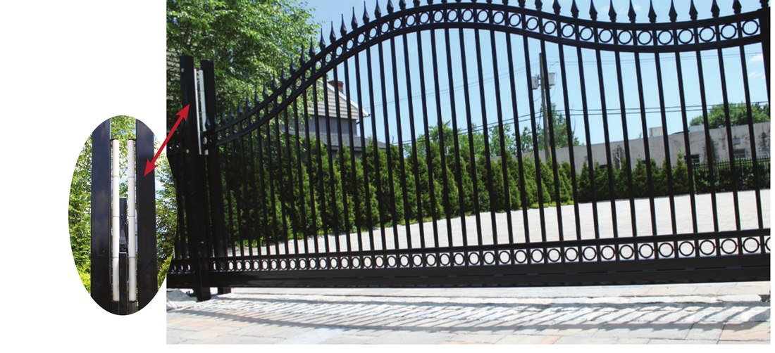 Photo of an arched ornamental gate with a side roller guidepost extending above the end height of the gate
