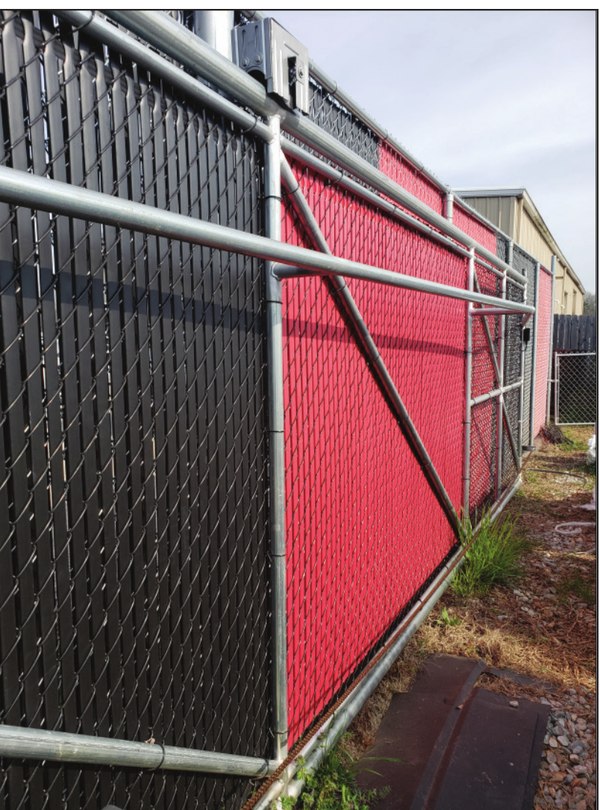 Photo of a lateral strong-arm support panel attached perpendicular to a cantilever gate to resist wind load